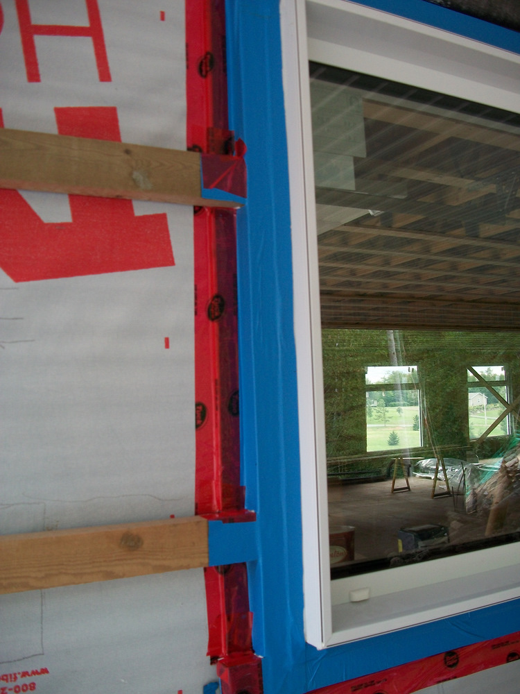 Blueskin sealed and tuck taped back to the housewrap.