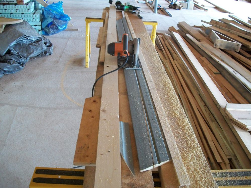 Taper ripping the pre-finished Cape Cod cove siding with a Rigid circular saw.