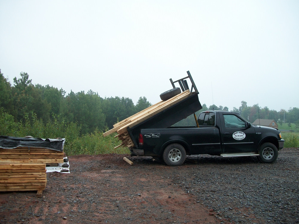Walter Hurlburt of Pleasant Valley delivers hackmatack for the raised bed gardens.