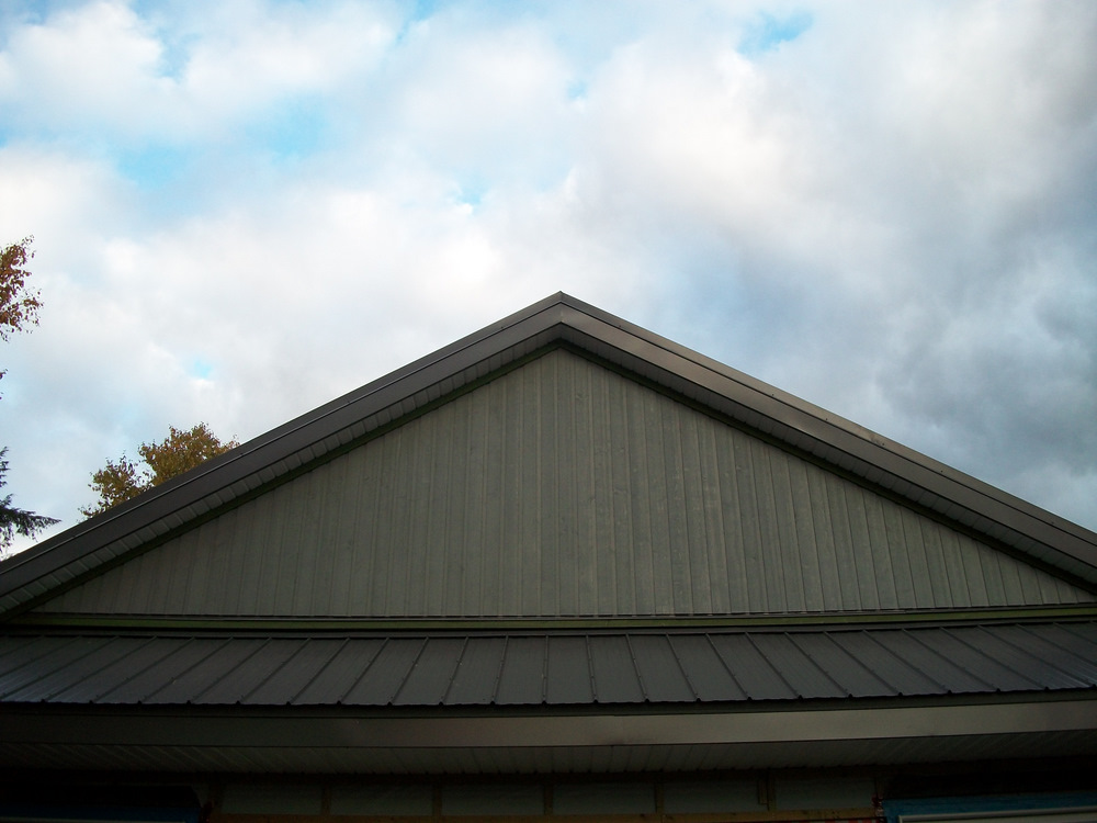 Finished west gable in 5" channel vertical siding.