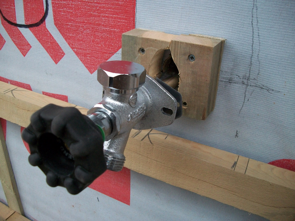 Firm backing for outside taps. They have the valve located 12" inside the house.