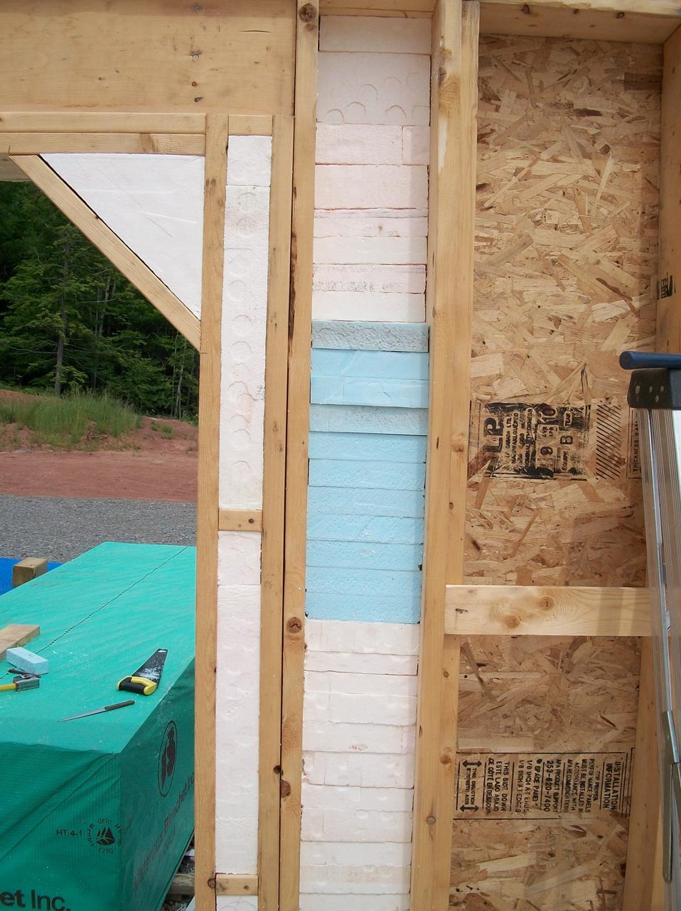 Using floor scraps to insulate around the garage door. The absurdity of an R30 wall at this point juztaposed against an R6 steel door. At least I have passed the Scottish (1/2" Jewish) test