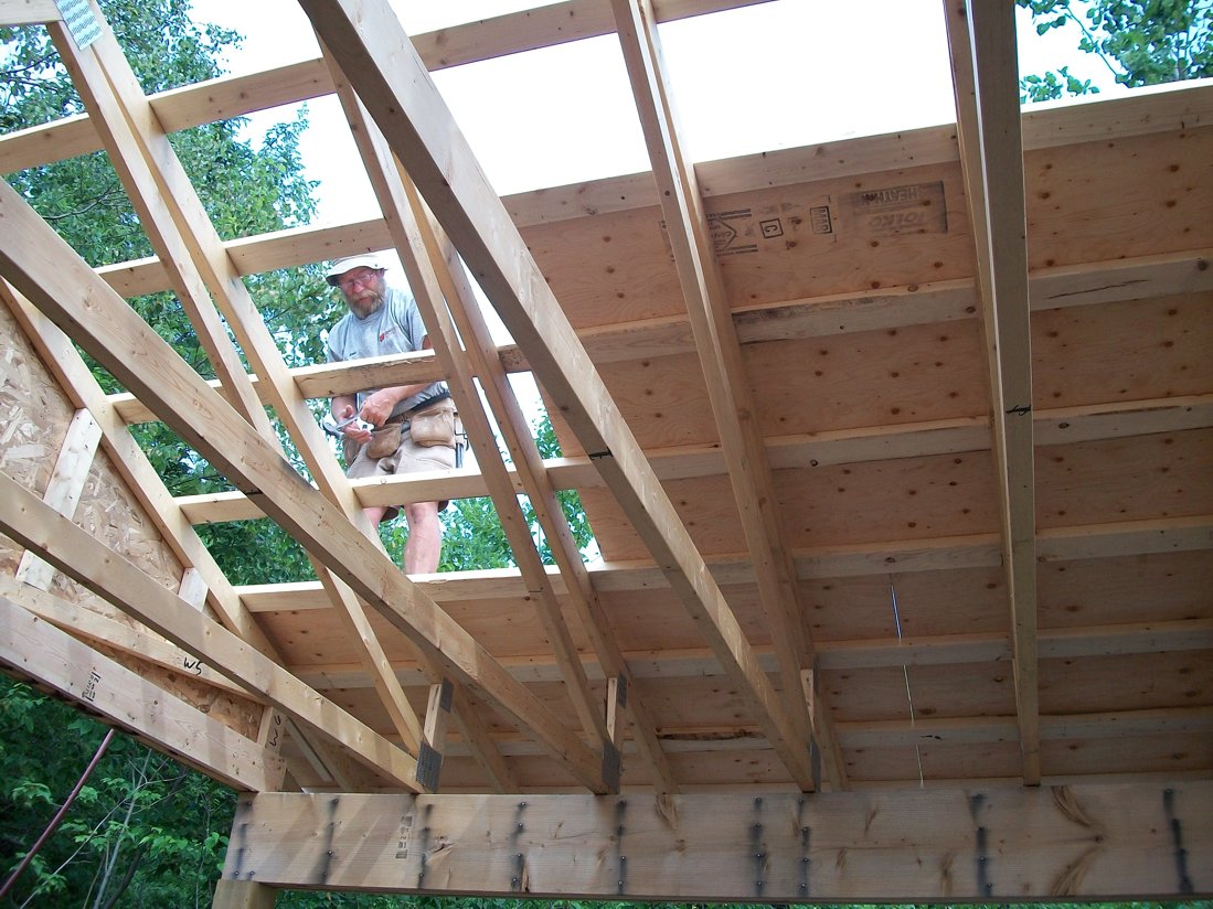 Etienne looking in earnest or at least serious! The proper way to do a steel roof. Ply on top of strapping with no nail points showing.