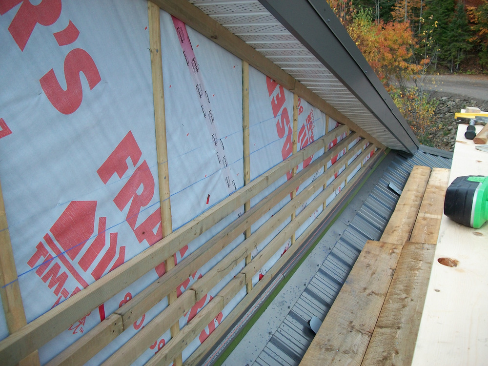 Strapping the gable end with 1-1/4" x 2-1/8" PT strapping.
